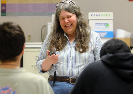 Teacher laughing with students