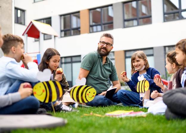 Outside elementary school class learning about bees