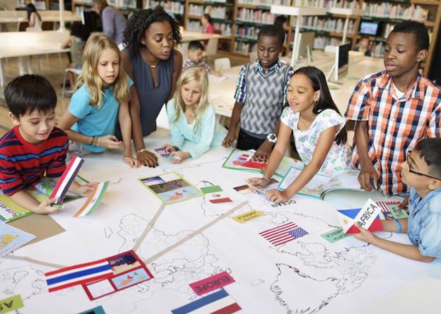 elementary school geography teacher with students